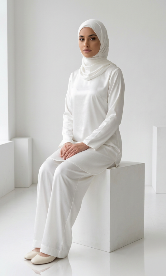 A sitting woman wearing white coord set