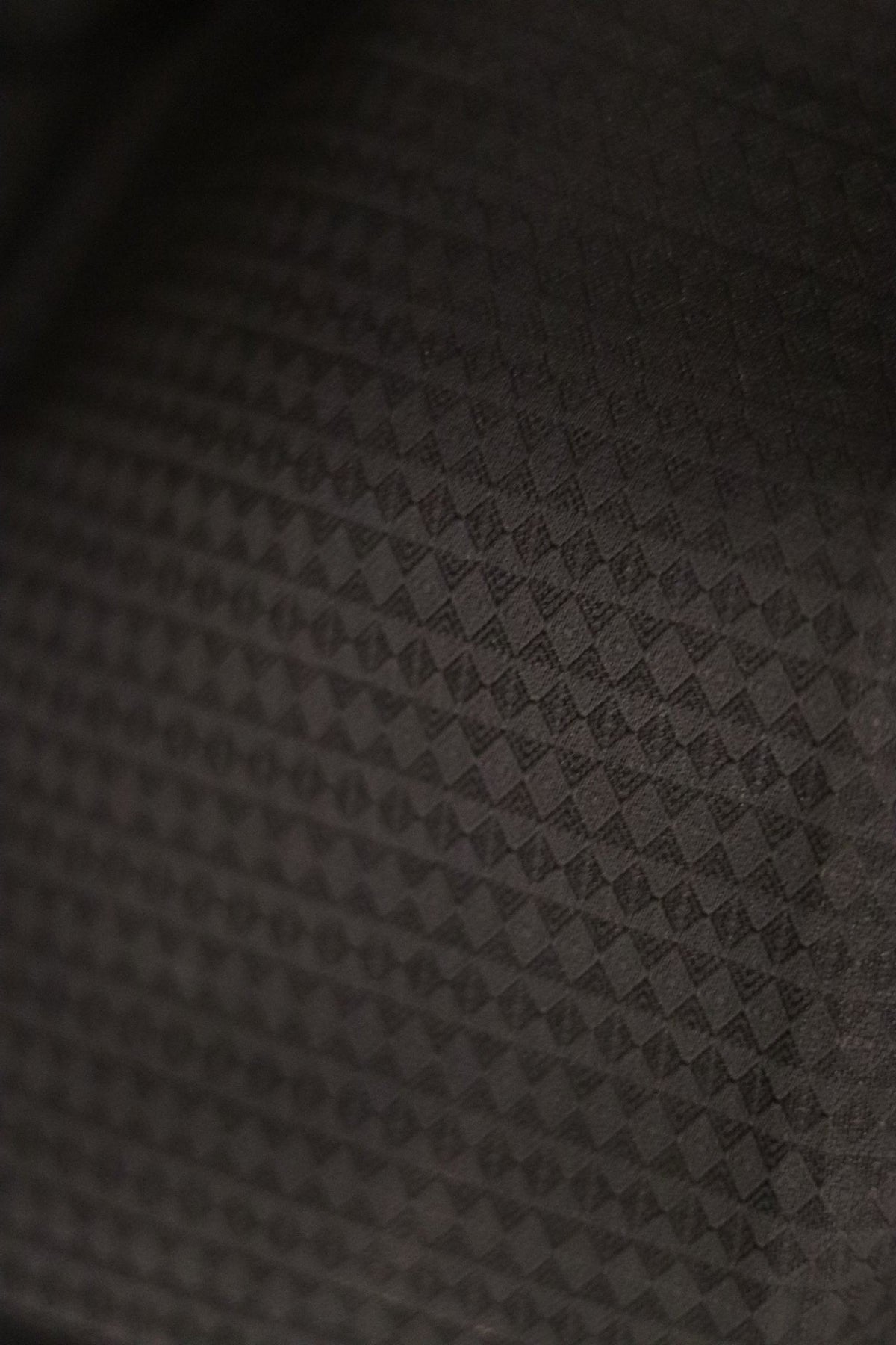 A close up of the fabric in black showing self print