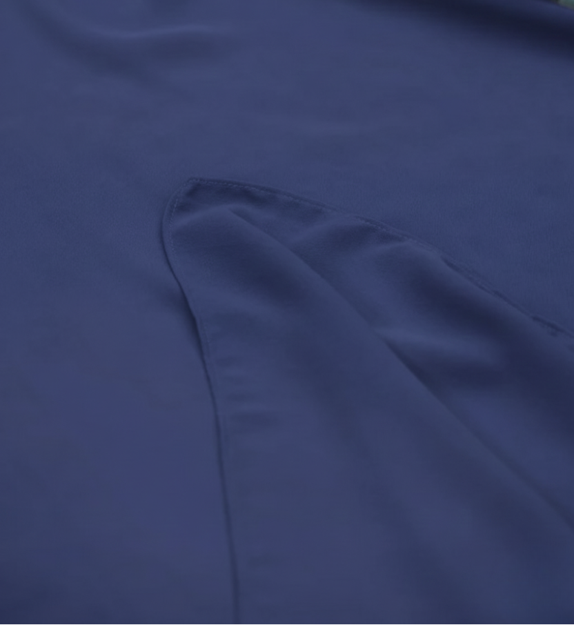 Navy blue fabric with a floral arrangement in the corner