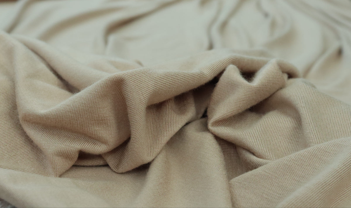 Close-up of beige fabric with a blurred background