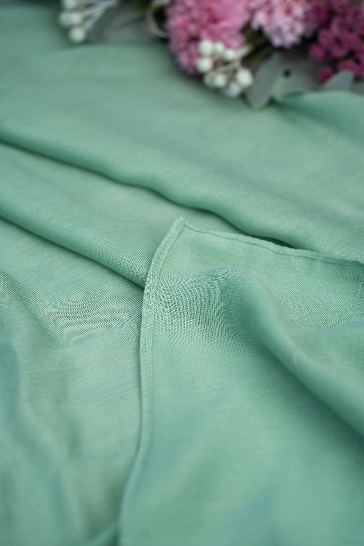 Close-up of a green fabric with a blurred background