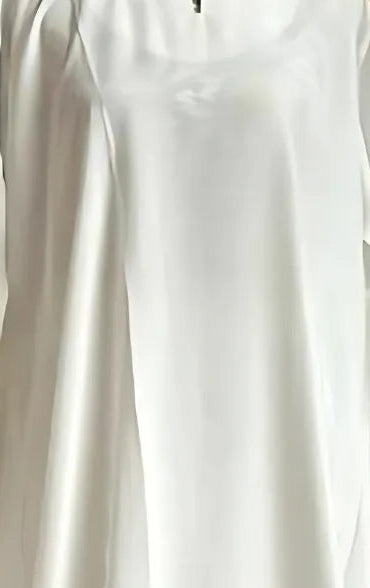 A close up of woman wearing off white colour dress.