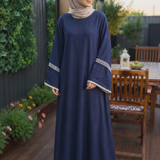 Elegant navy blue pashmina abaya dress featuring embroidered wide sleeves with lace trim, a flowing full-length silhouette, and a relaxed modest fit.