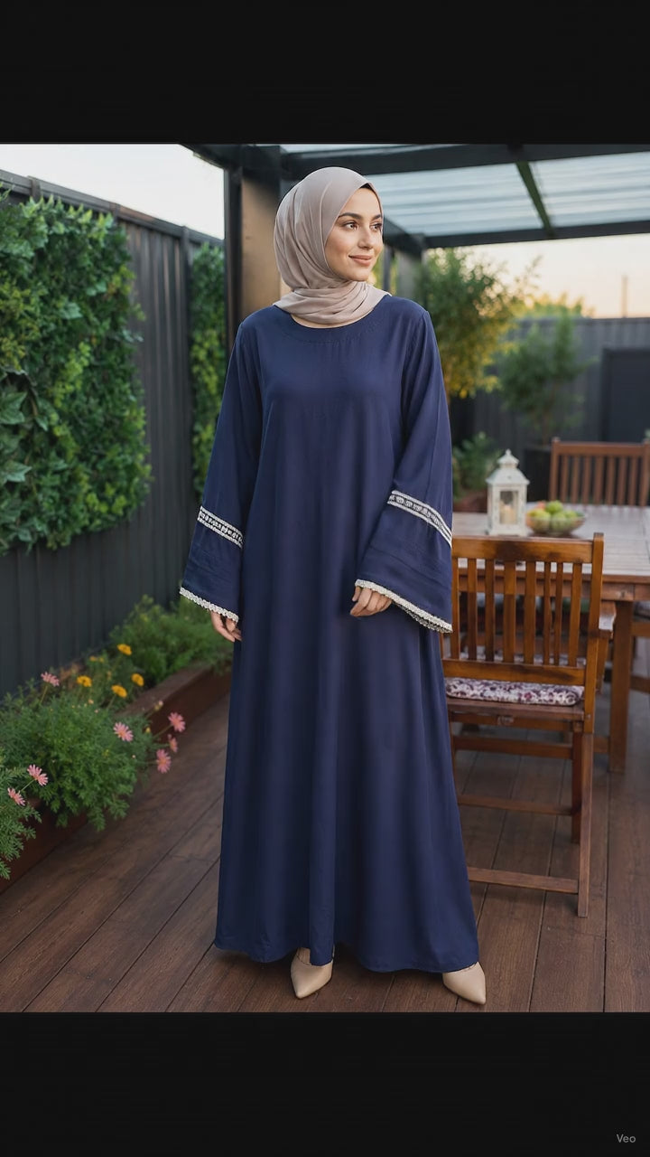 Elegant navy blue pashmina abaya dress featuring embroidered wide sleeves with lace trim, a flowing full-length silhouette, and a relaxed modest fit.