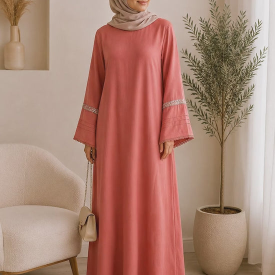 Elegant dusty rose pashmina abaya dress featuring embroidered wide sleeves, a flowing maxi silhouette, and a modest relaxed fit.