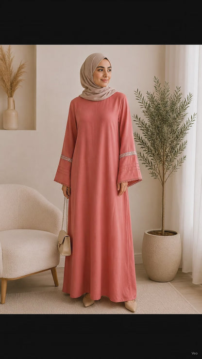 Elegant dusty rose pashmina abaya dress featuring embroidered wide sleeves, a flowing maxi silhouette, and a modest relaxed fit.