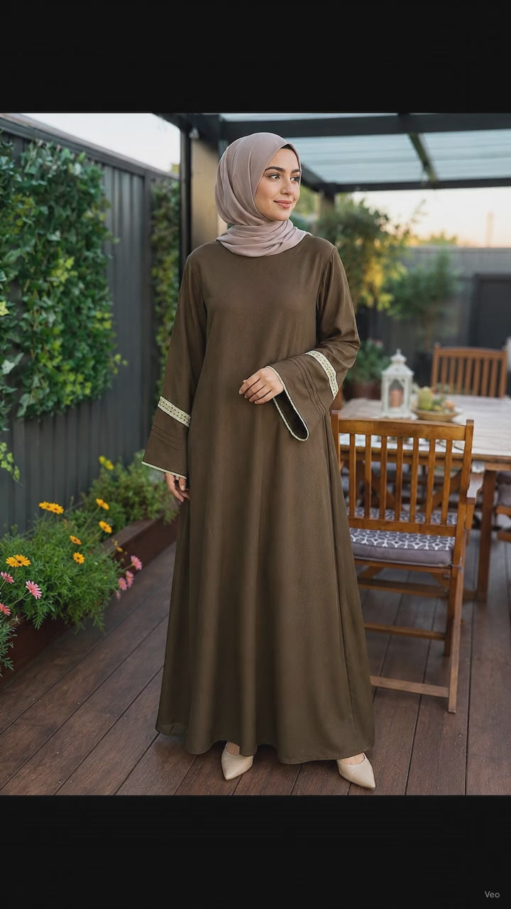 Elegant mocha brown pashmina abaya dress featuring embroidered wide sleeves, a flowing maxi silhouette, and a modest relaxed fit.