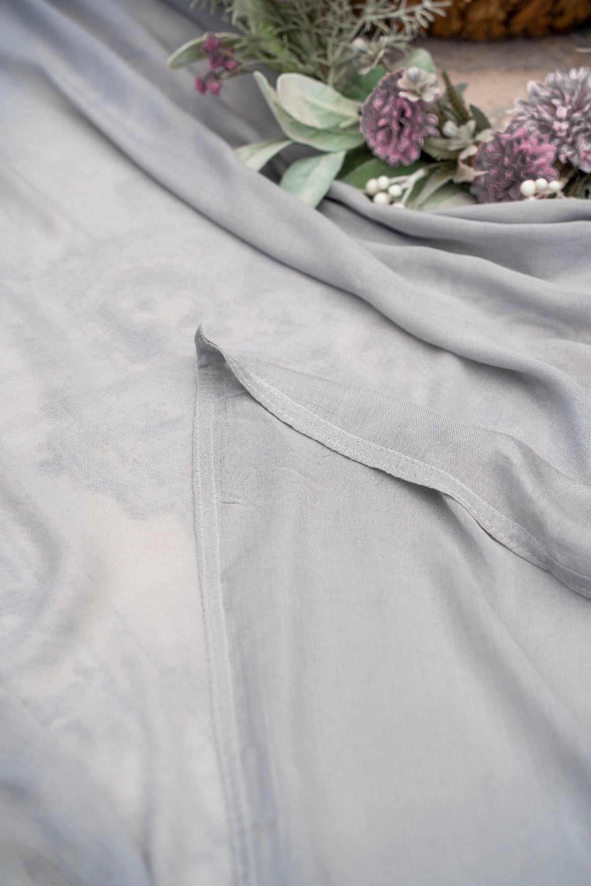 Gray fabric with a floral arrangement on a textured surface