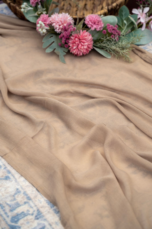 Floral arrangement on a beige fabric surface