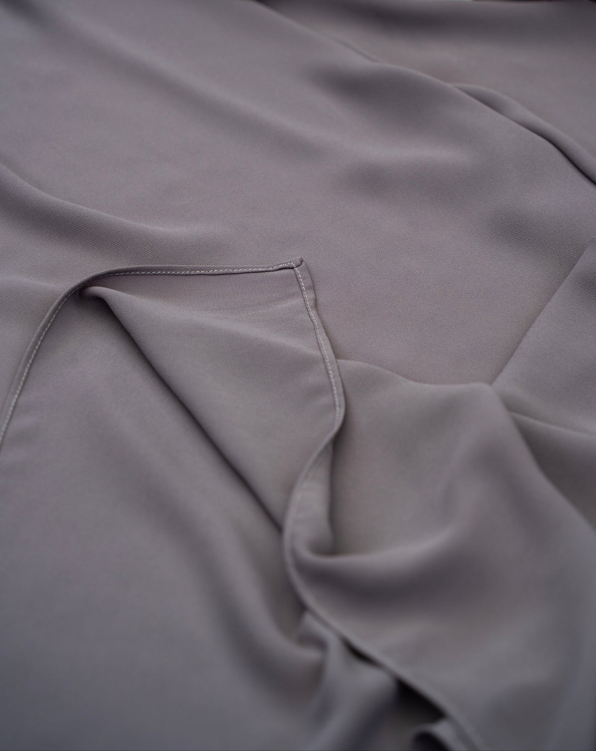 Gray fabric with a floral arrangement in the corner