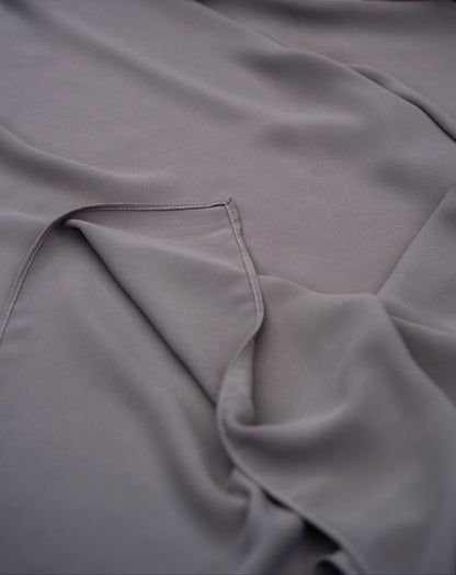 Gray fabric with a floral arrangement in the corner