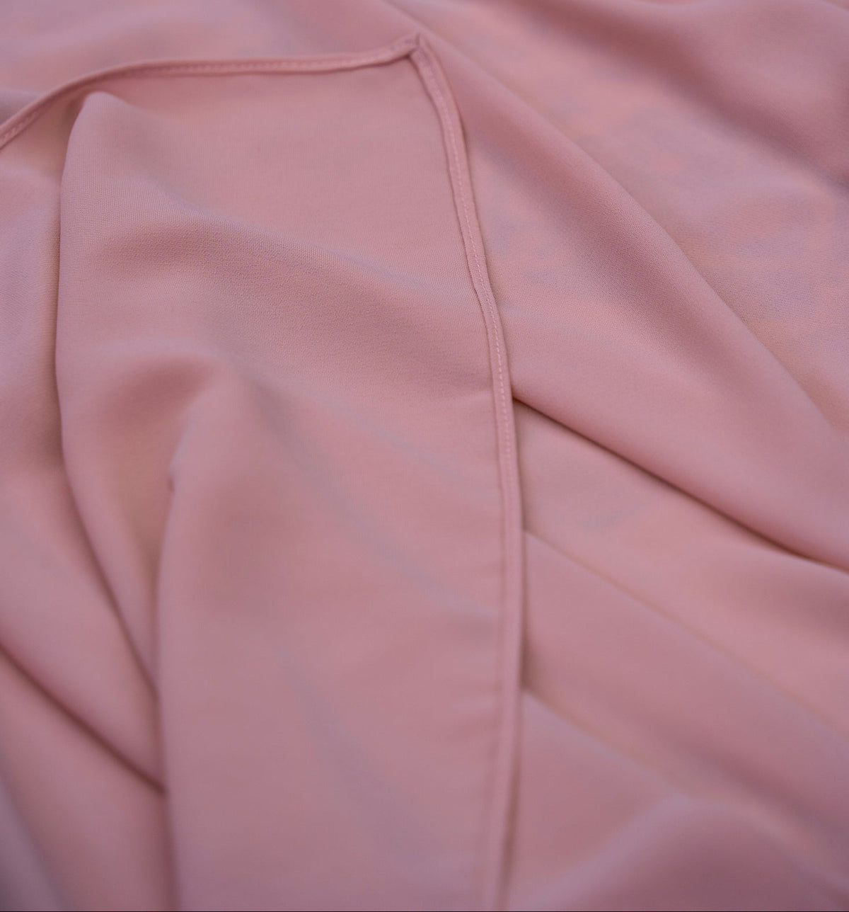 Close-up of a pink fabric with a fold