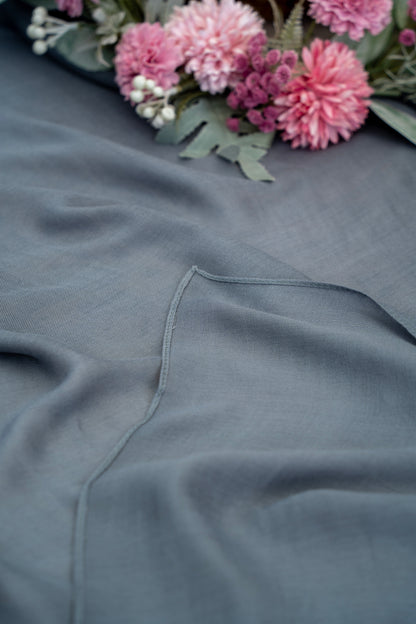 Gray fabric with a floral arrangement in the background