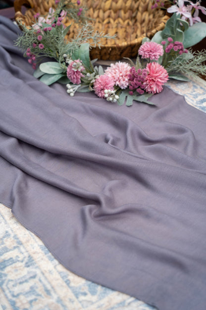 Floral arrangement on a textured surface with a blanket