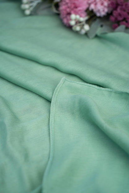 Close-up of a green fabric with a blurred background