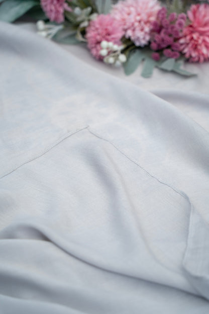 Gray fabric with a floral arrangement in the background