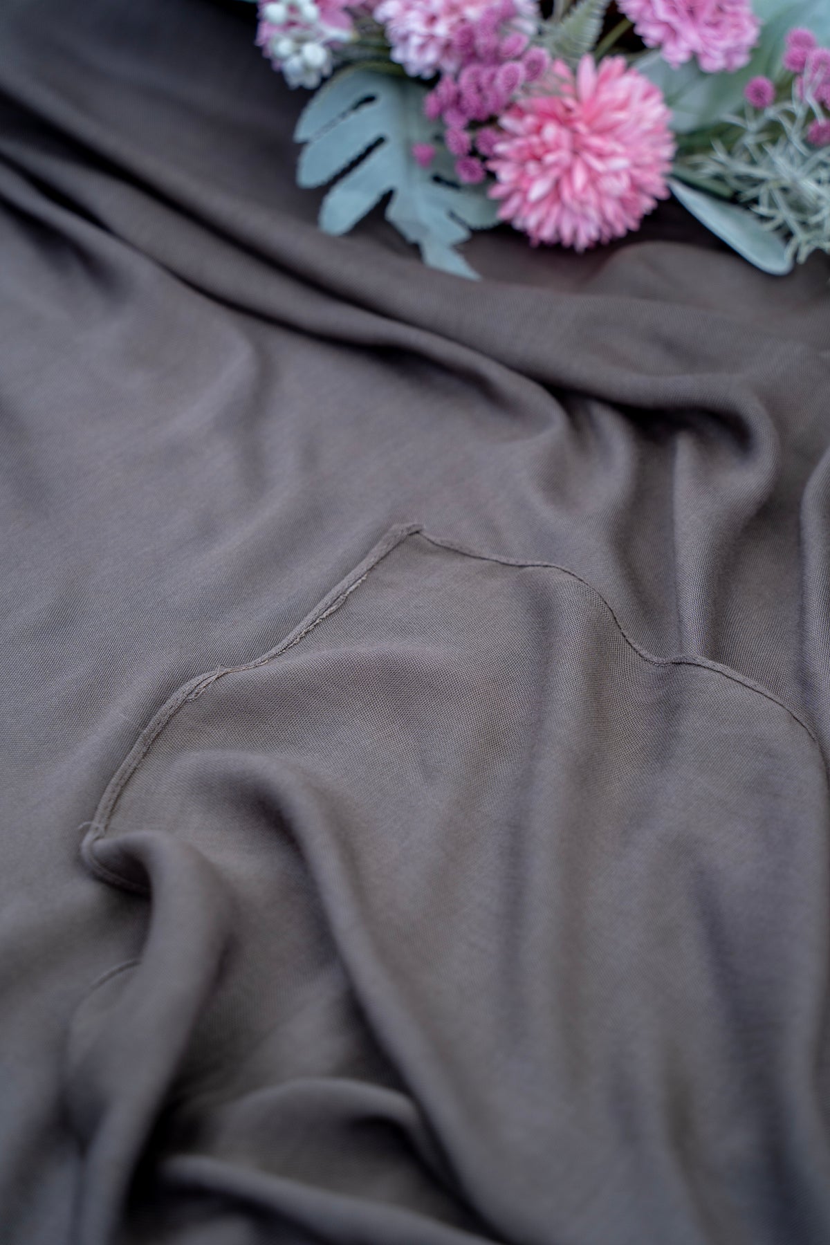 Gray fabric with a floral arrangement on top