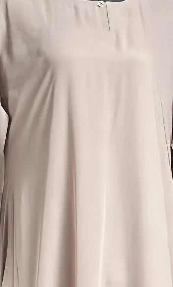 A close up of woman wearing beige colour dress.