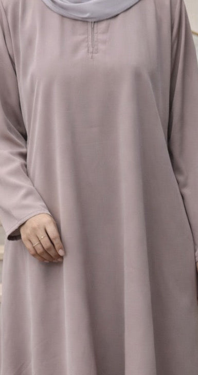 A close up of woman wearing light-colored dress.